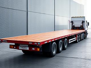 An extendable flatbed trailer transporting a long industrial component
